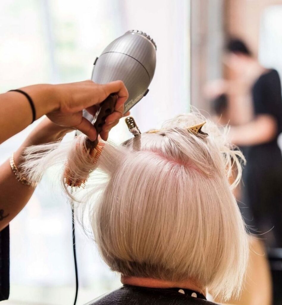 Blonde balayage being blow dried